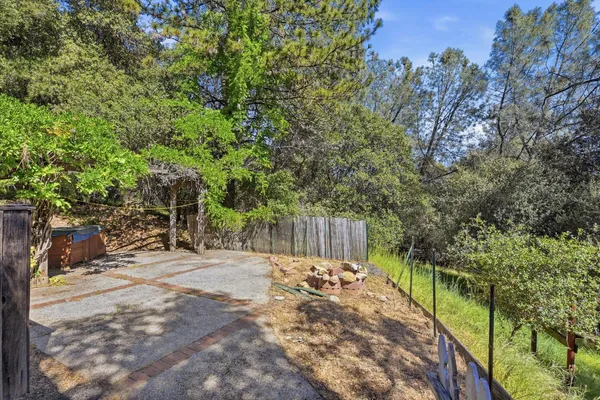 a view of a backyard with large trees