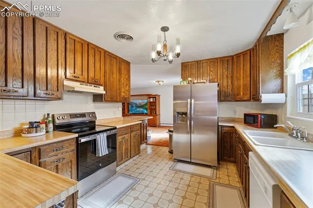 a kitchen with refrigerator cabinets and a sink