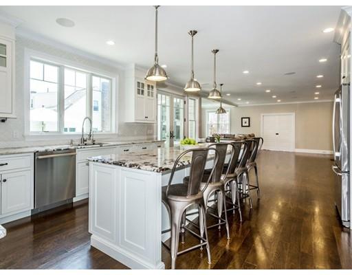 17 Ridgeway Avenue Needham, MA 02492 - Photo 2 of 30 a kitchen with stainless steel appliances kitchen island granite countertop a stove a sink a dining table and chairs