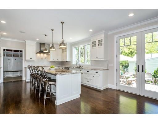 17 Ridgeway Avenue Needham, MA 02492 - Photo 5 of 30 a kitchen with stainless steel appliances kitchen island granite countertop a stove a refrigerator a sink a dining table and chairs with wooden floor
