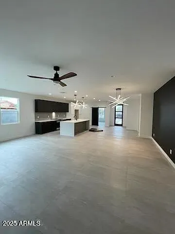 a view of empty room with a ceiling fan and window
