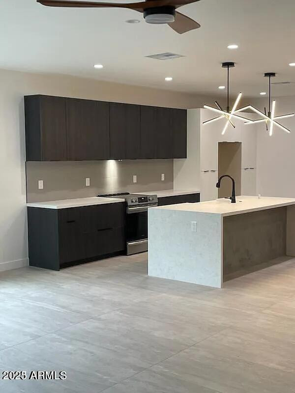 2826 North 28th Place Phoenix, AZ 85008 - Photo 8 of 8 a large kitchen with stainless steel appliances a large counter top a stove and a sink
