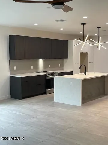 a large kitchen with a large counter top cabinets and stainless steel appliances