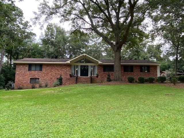 206 Smithfield Road Dublin, GA 31021 - Photo 1 of 1 a front view of house with yard and trees