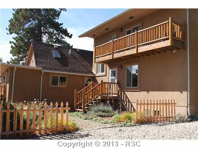 1122 NORTH Rd Divide Divide, CO 80814 - Photo 5 of 25 Log railings and a nice courtyard for plantings. Upper deck is to main master suite and staircase goes to main level master
