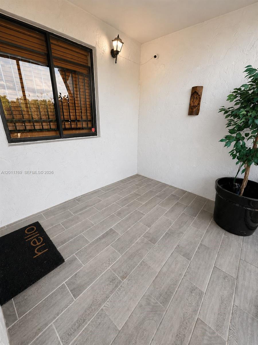 286 Racquet Club Road, Unit 204 Weston, FL 33326 - Photo 3 of 11 a view of a hardwood floor and a potted plant
