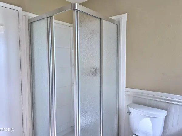a bathroom with a shower and a toilet