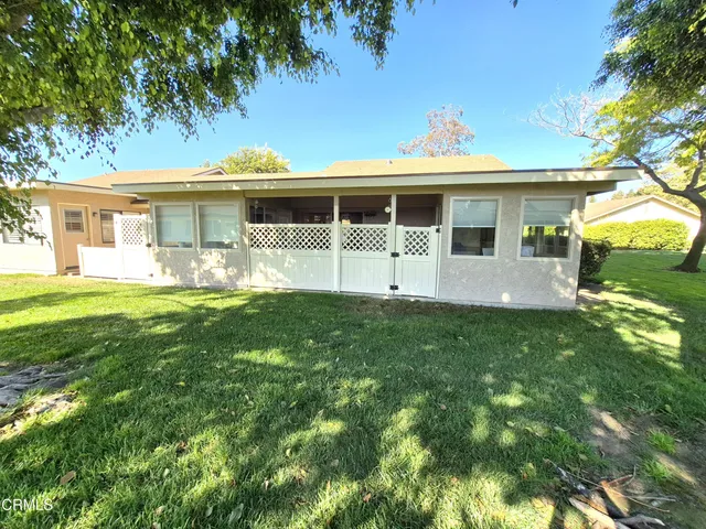 a front view of a house with a garden and yard