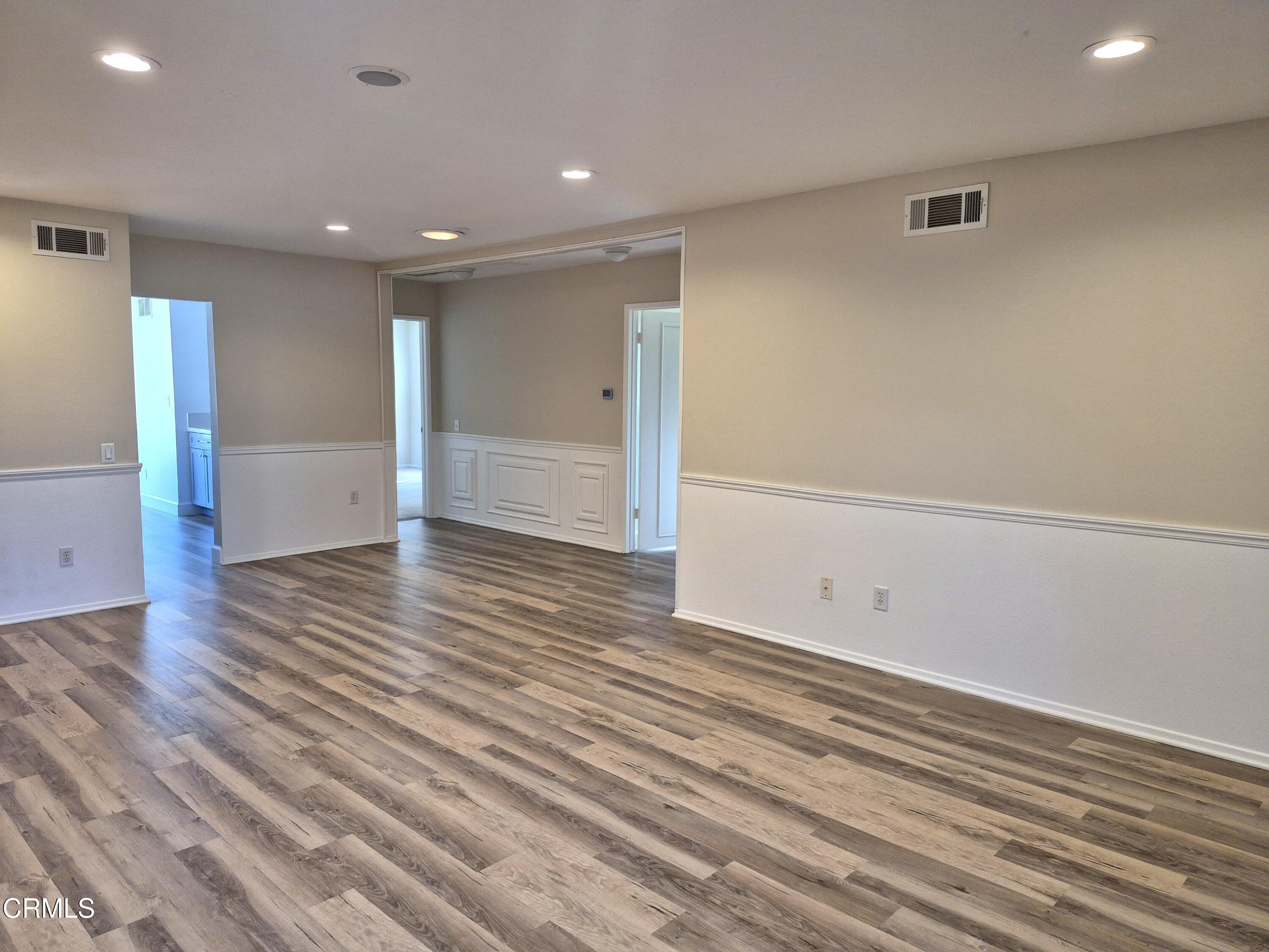 7107 Village 7 Camarillo, CA 93012 - Photo 3 of 21 an empty room with wooden floor and windows