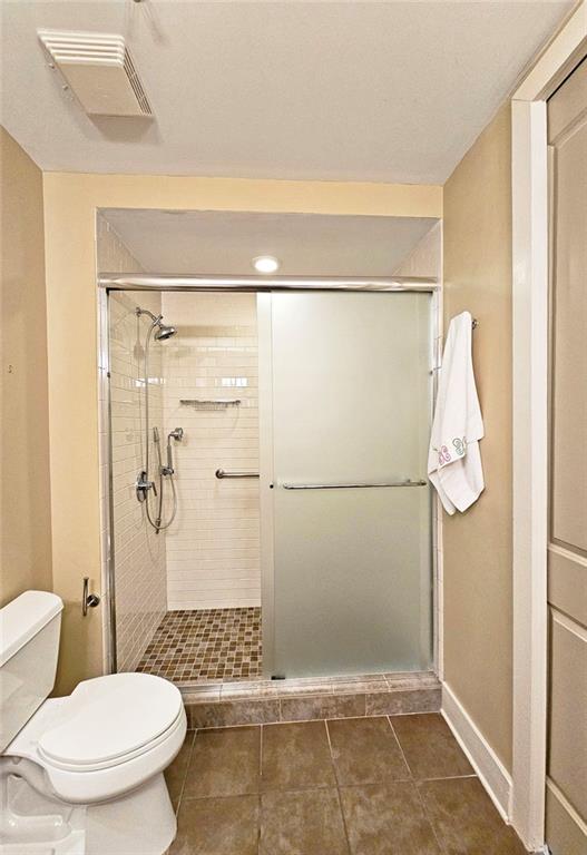4561 Olde Perimeter Way, Unit 704 Atlanta, GA 30346 - Photo 13 of 45 a bathroom with a toilet and a shower