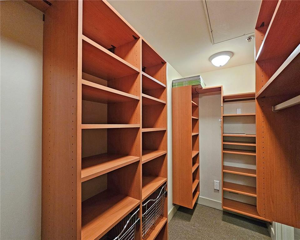 4561 Olde Perimeter Way, Unit 704 Atlanta, GA 30346 - Photo 19 of 45 a view of walk in closet with empty racks