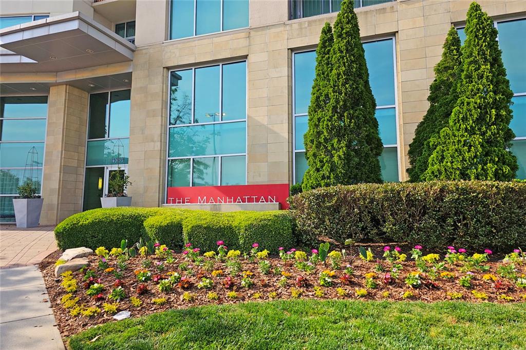 4561 Olde Perimeter Way, Unit 704 Atlanta, GA 30346 - Photo 3 of 45 a view of a flower garden with a large tree