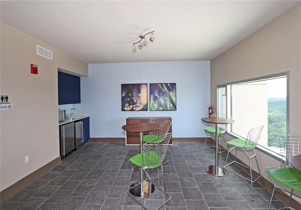 4561 Olde Perimeter Way, Unit 704 Atlanta, GA 30346 - Photo 39 of 45 a living room with furniture and a wooden floor