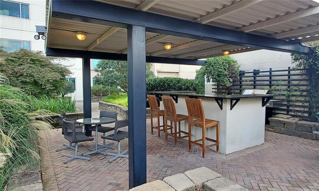 4561 Olde Perimeter Way, Unit 704 Atlanta, GA 30346 - Photo 41 of 45 a patio with table and chairs
