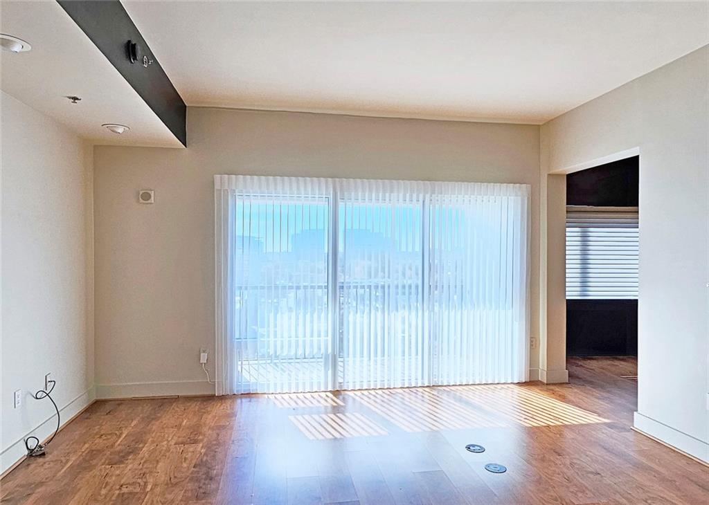 4561 Olde Perimeter Way, Unit 704 Atlanta, GA 30346 - Photo 7 of 45 an empty room with wooden floor and windows