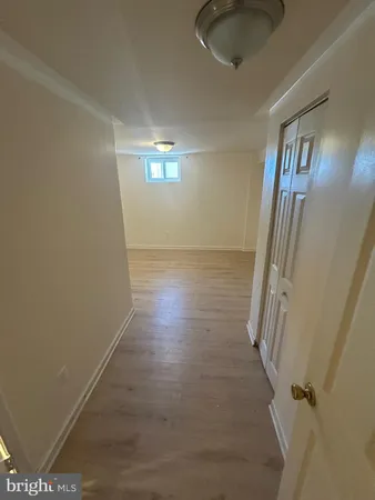a view of a livingroom with wooden floor and staircase