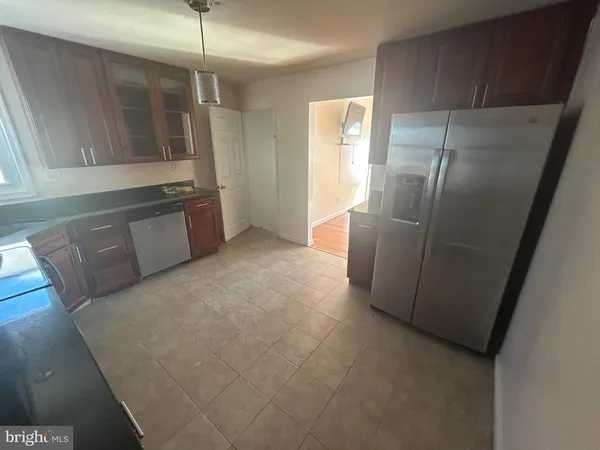 a kitchen with stainless steel appliances granite countertop a refrigerator a sink and a stove