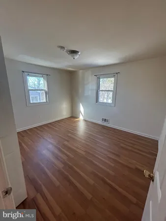 a view of room with window and hardwood floor