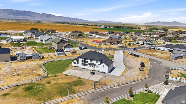 3644 Spiral Springs Road Tooele, UT 84074 - Photo 39 of 41 Contemporary-style residence featuring a dark shingle roof, expansive multi-pane windows, and a concrete driveway