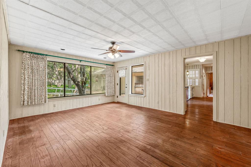1222 Kentucky Street Graham, TX 76450 - Photo 13 of 37 a view of an empty room with wooden floor and a window