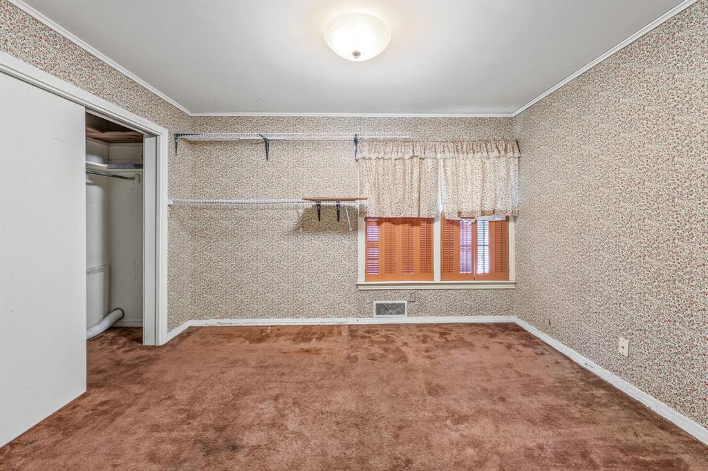 1222 Kentucky Street Graham, TX 76450 - Photo 17 of 37 an empty room with windows