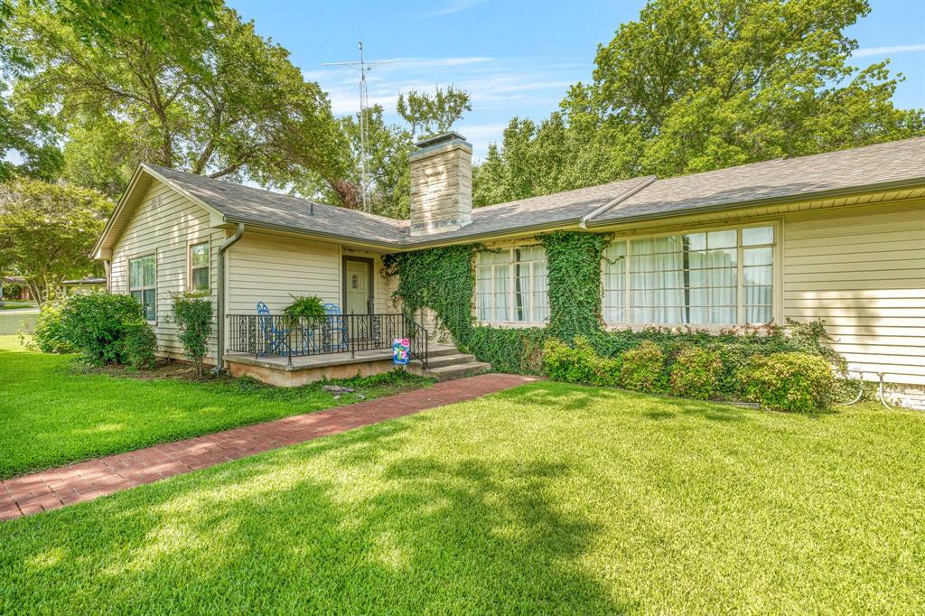 1222 Kentucky Street Graham, TX 76450 - Photo 2 of 37 a view of a house with backyard and porch