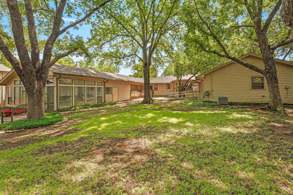 1222 Kentucky Street Graham, TX 76450 - Photo 27 of 37 a view of a house with backyard and tree