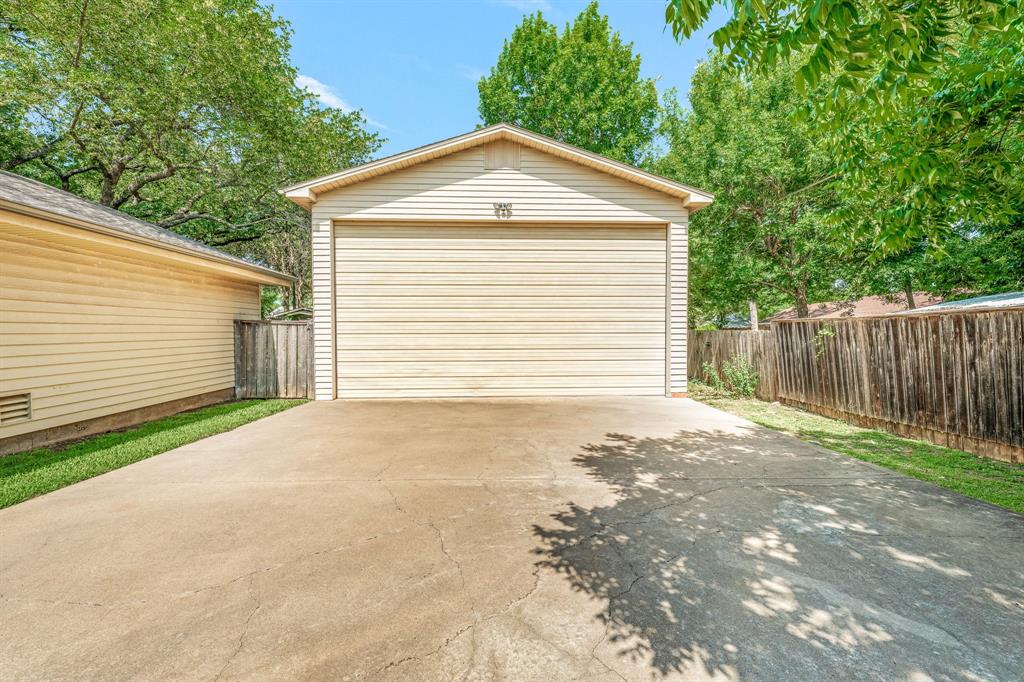 1222 Kentucky Street Graham, TX 76450 - Photo 34 of 37 a front view of a house with a yard and garage