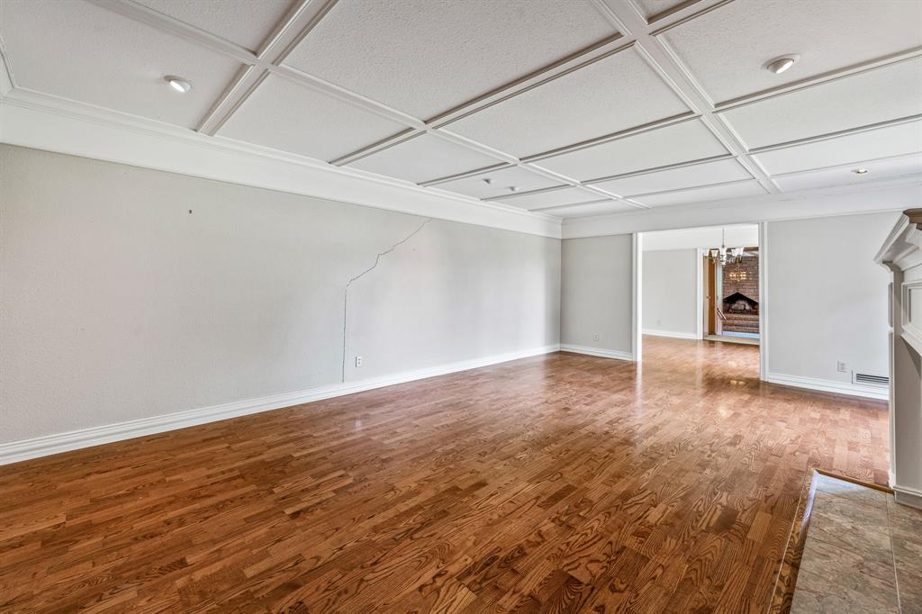 1222 Kentucky Street Graham, TX 76450 - Photo 4 of 37 a view of an empty room with wooden floor