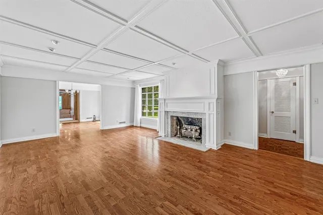 a view of an empty room with window and fire place