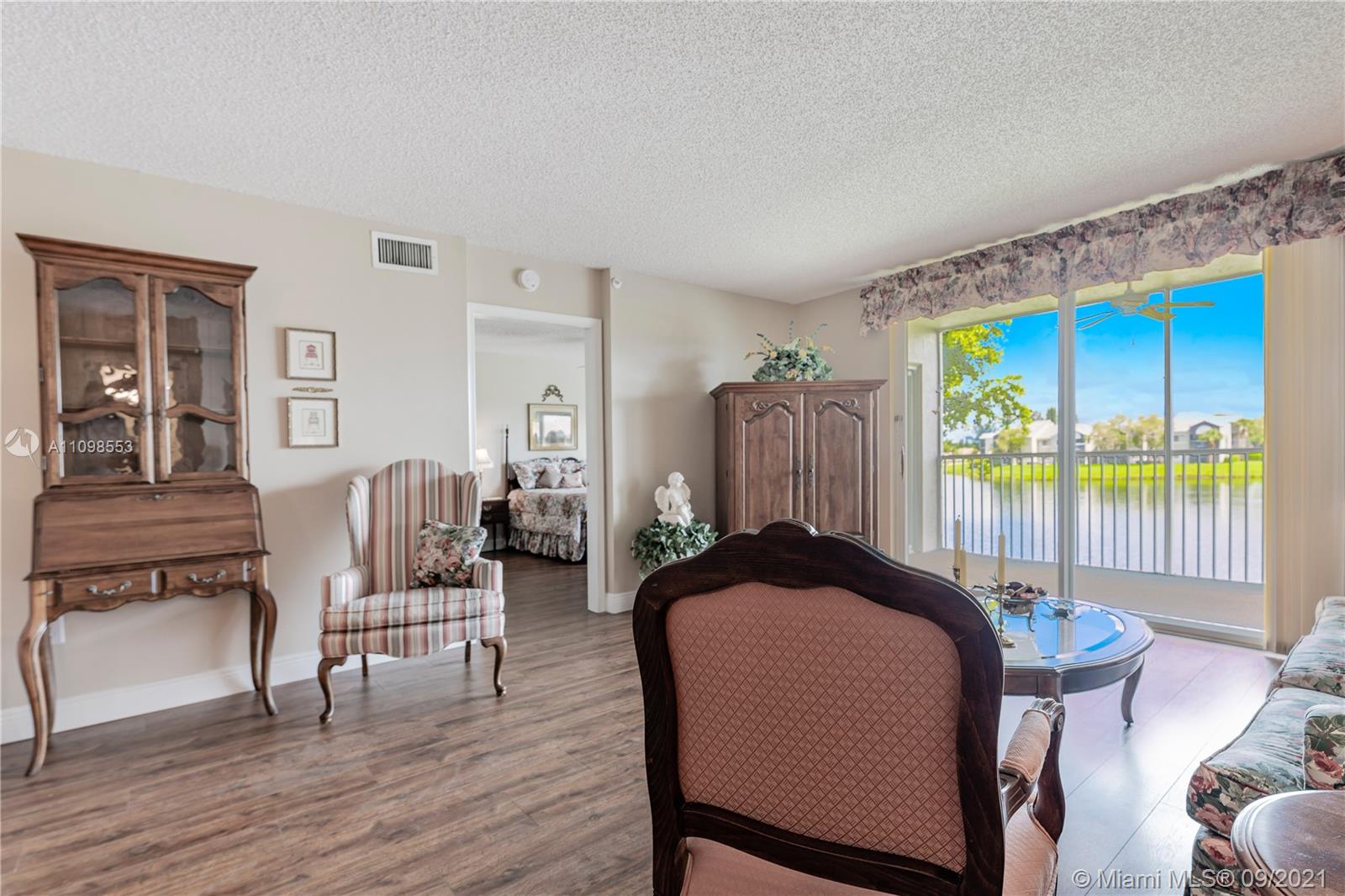 a bedroom with a bed and large windows