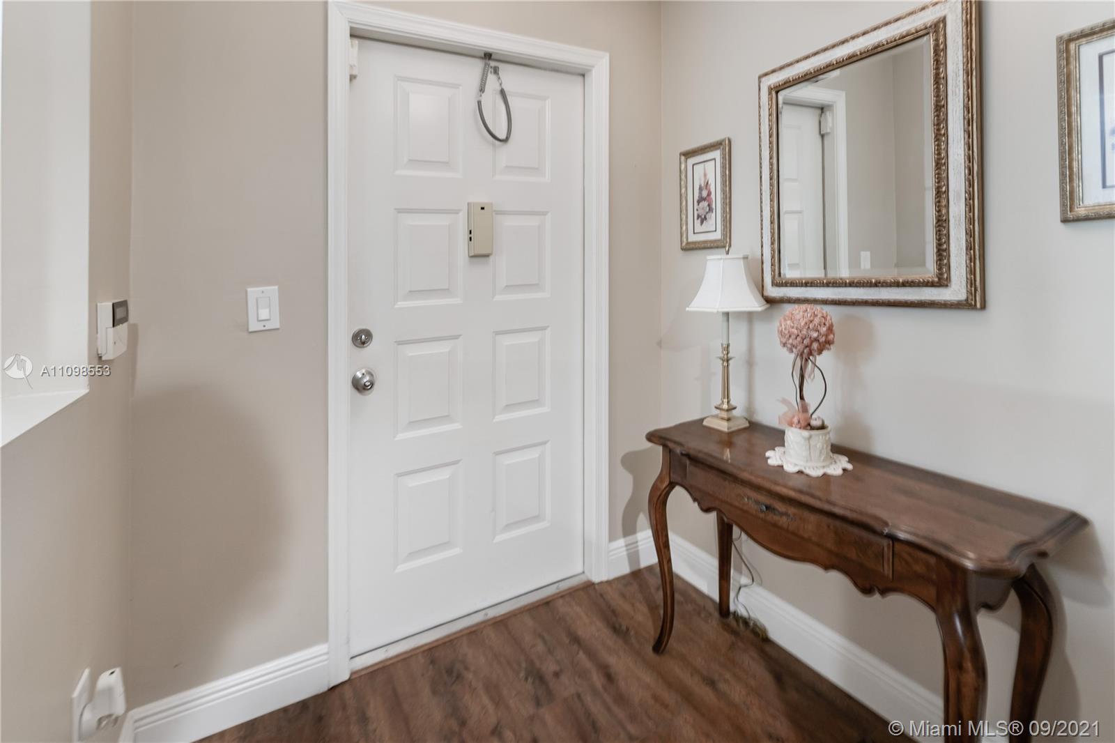 9563 Weldon Circle, Unit D207 Tamarac, FL 33321 - Photo 12 of 40 a view of bathroom with a table and a mirror