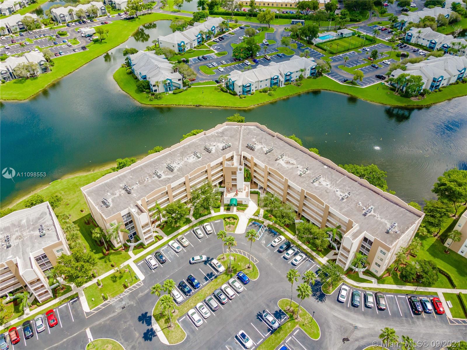 9563 Weldon Circle, Unit D207 Tamarac, FL 33321 - Photo 3 of 40 an aerial view of a house with a lake view