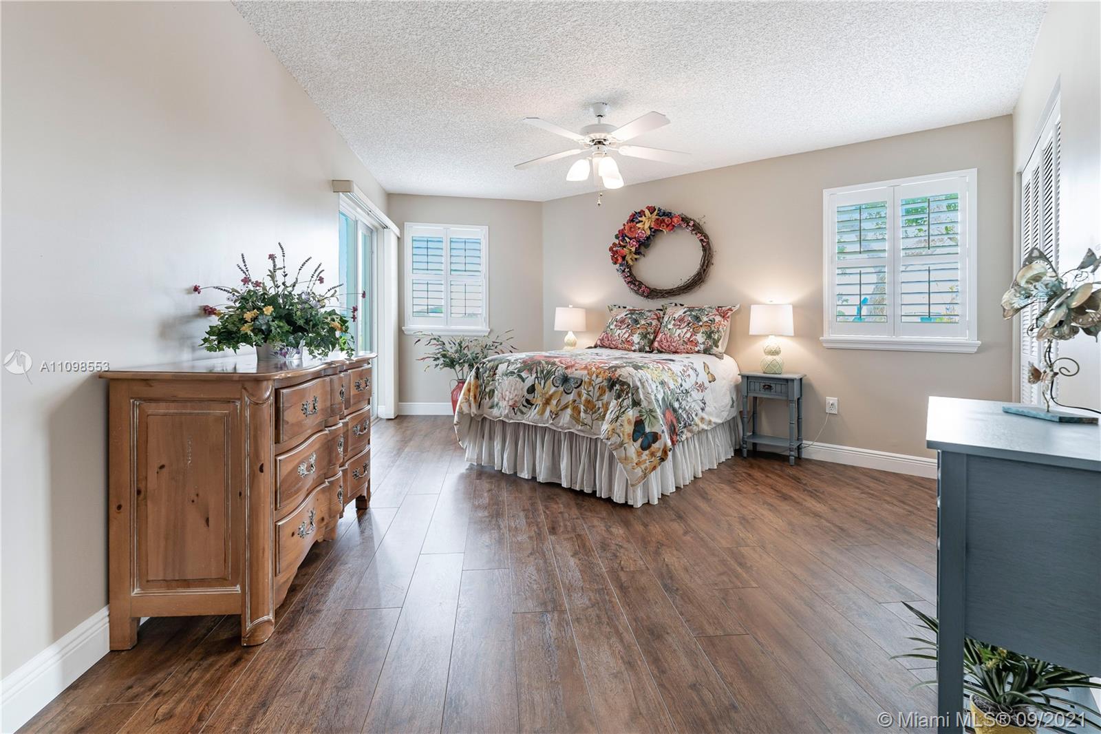 9563 Weldon Circle, Unit D207 Tamarac, FL 33321 - Photo 23 of 40 a bed room with a bed mirror and a window