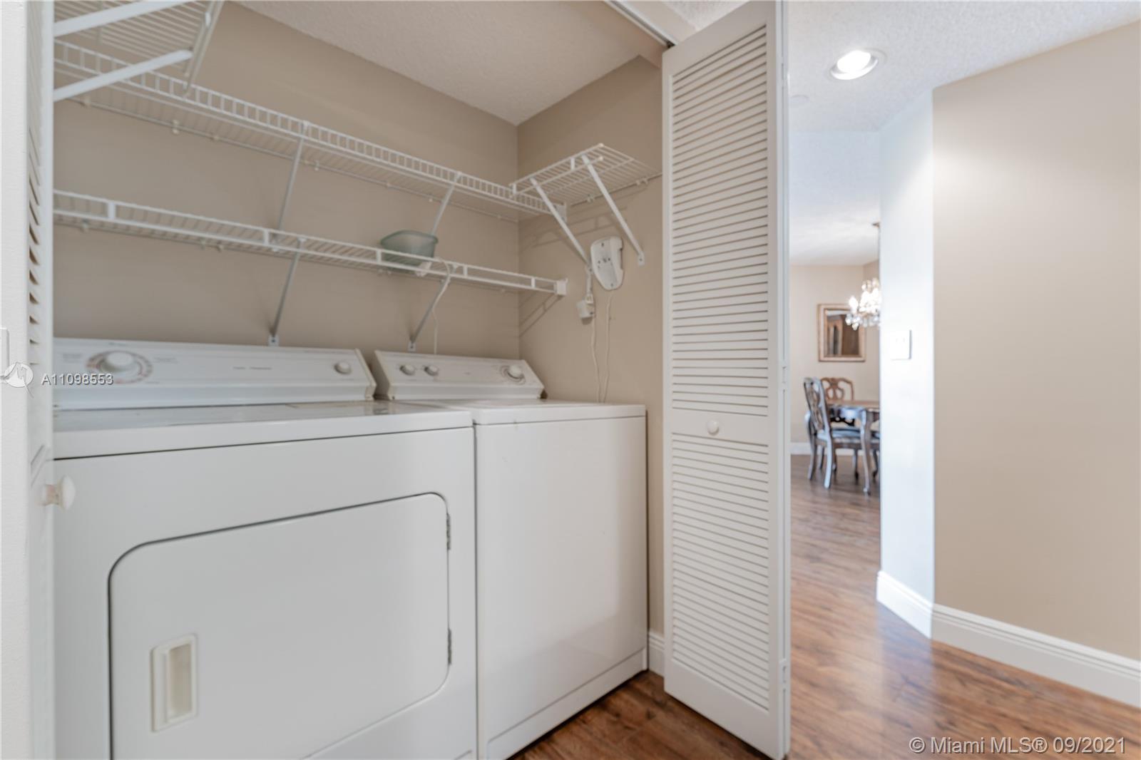 9563 Weldon Circle, Unit D207 Tamarac, FL 33321 - Photo 29 of 40 a utility room with dryer and washer