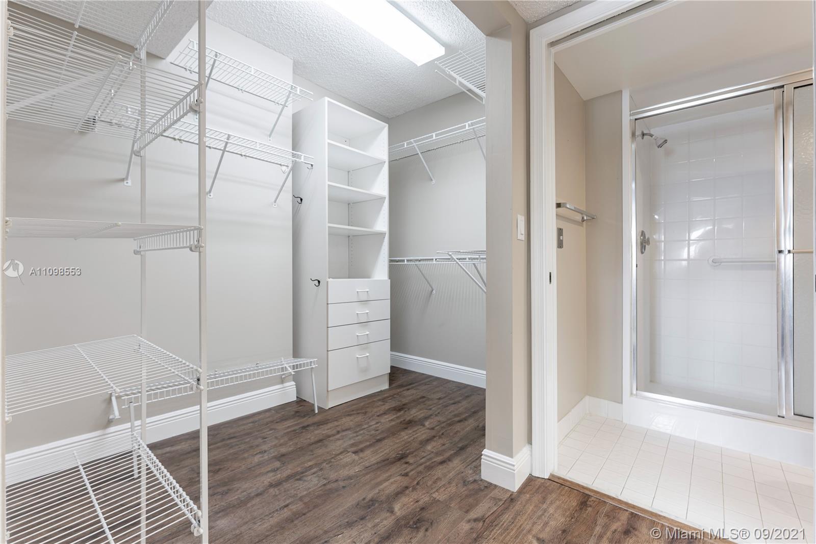 9563 Weldon Circle, Unit D207 Tamarac, FL 33321 - Photo 34 of 40 a view of an empty room with wooden floor and a bathroom