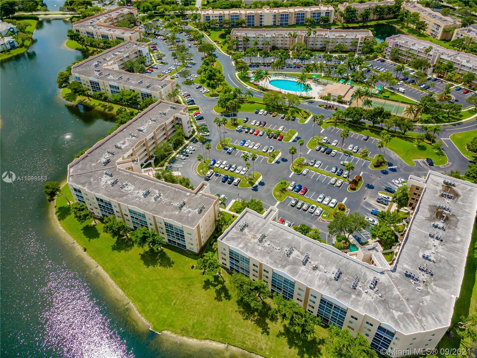 9563 Weldon Circle, Unit D207 Tamarac, FL 33321 - Photo 5 of 40 an aerial view of a house with a garden and lake view