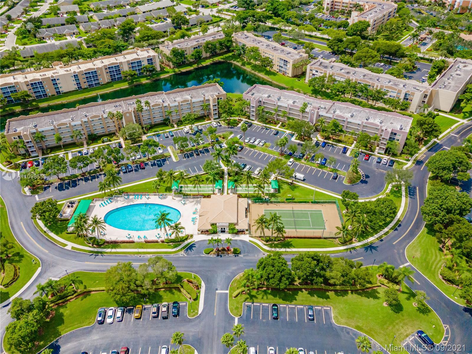 9563 Weldon Circle, Unit D207 Tamarac, FL 33321 - Photo 6 of 40 an aerial view of a house with a garden and lake view