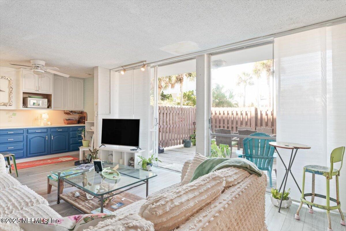 901 Ocean Boulevard, Unit 1 Atlantic Beach, FL 32233 - Photo 15 of 39 a living room with furniture and a flat screen tv