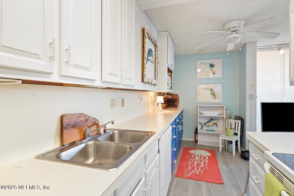 901 Ocean Boulevard, Unit 1 Atlantic Beach, FL 32233 - Photo 17 of 39 a kitchen with a sink stove and cabinets