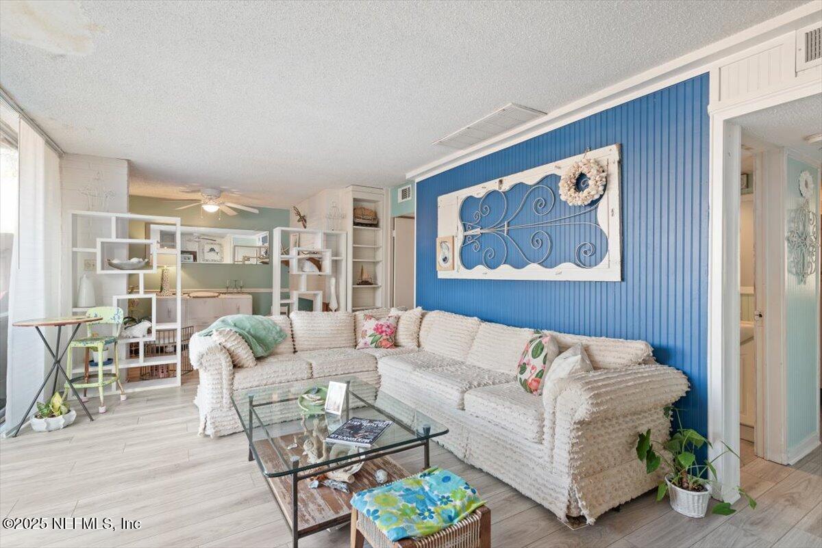 901 Ocean Boulevard, Unit 1 Atlantic Beach, FL 32233 - Photo 20 of 39 a living room with furniture and a painting on the wall