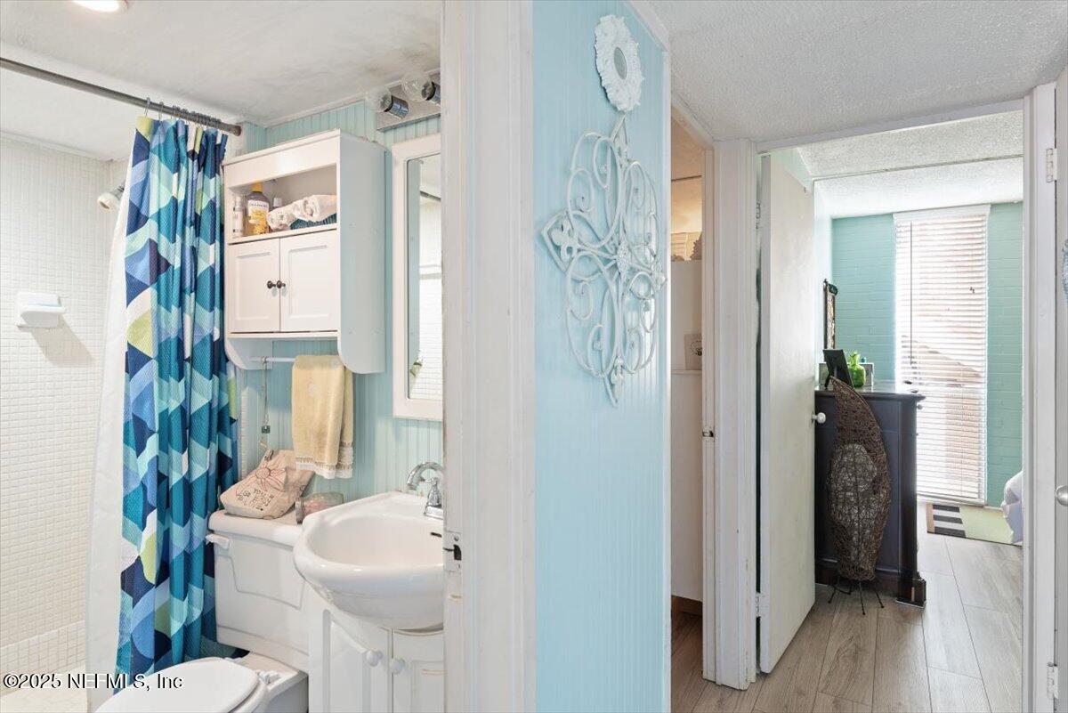 901 Ocean Boulevard, Unit 1 Atlantic Beach, FL 32233 - Photo 28 of 39 a bathroom with a sink toilet and shower