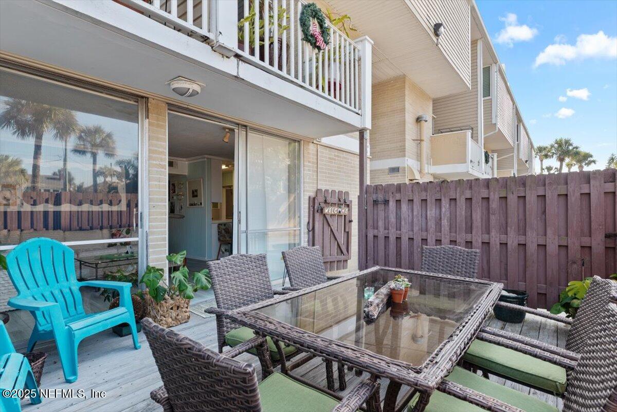 901 Ocean Boulevard, Unit 1 Atlantic Beach, FL 32233 - Photo 6 of 39 a table and chairs in a patio