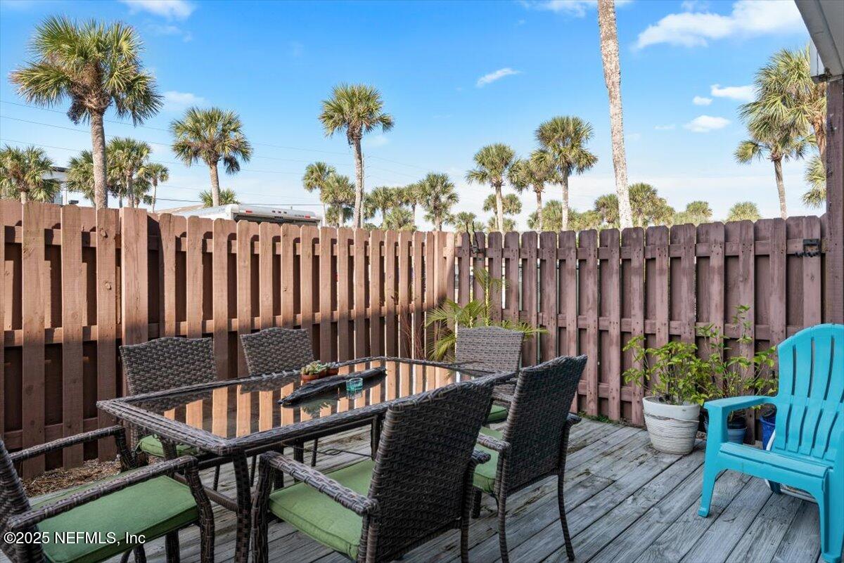 901 Ocean Boulevard, Unit 1 Atlantic Beach, FL 32233 - Photo 7 of 39 a view of a chairs in patio with wooden fence