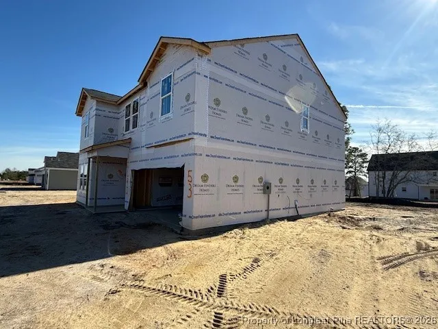 a view of a house with wooden fence