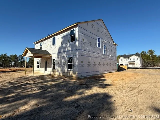 a front view of a house with a road