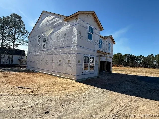 a view of a house with wooden fence