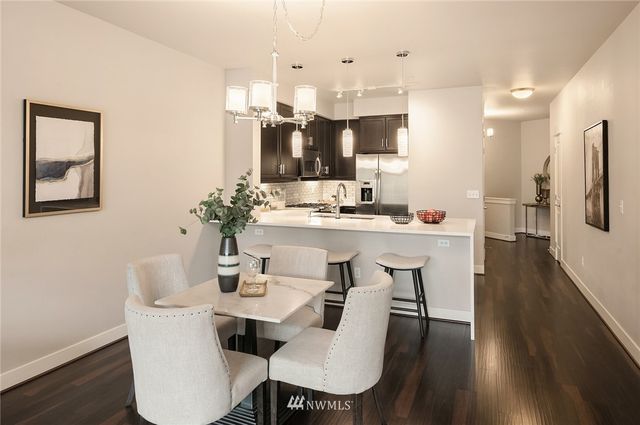a view of a dining room with furniture and wooden floor