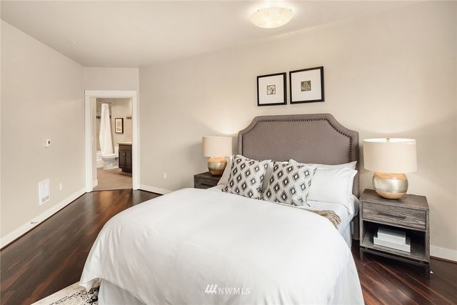 a bedroom with a bed and a lamp