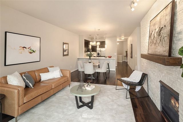 a living room with furniture and a painting on the wall